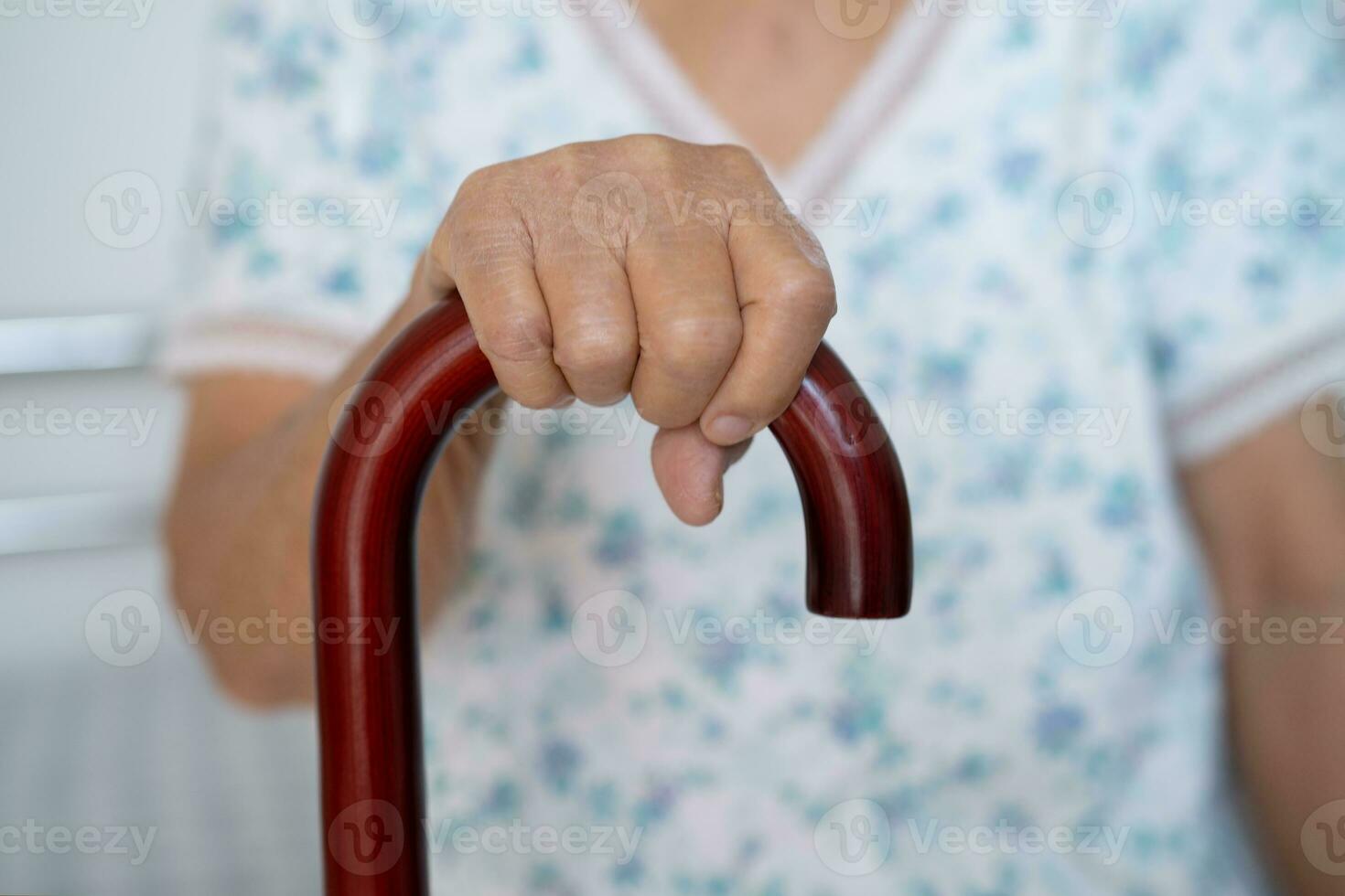 asiatisch Alten Behinderung Frau halten wackeln Stock, Holz Stock, runden handhaben, Gehen Hilfe zum Hilfe zu gehen. foto