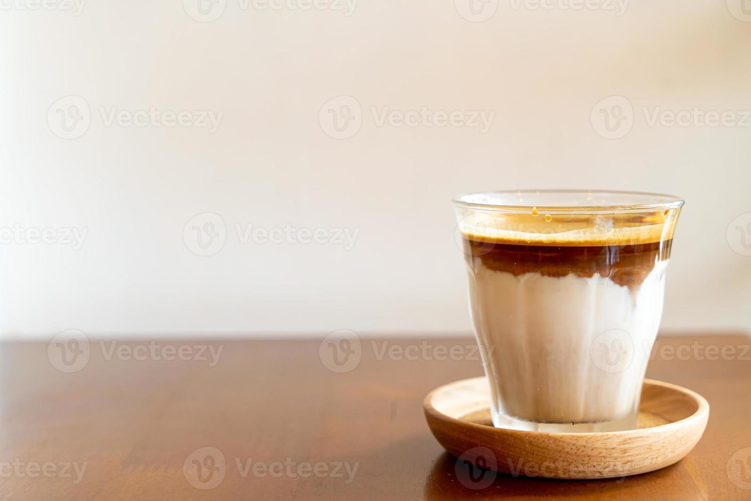 schmutziger Kaffee - ein Glas Espresso mit kalter frischer Milch gemischt foto