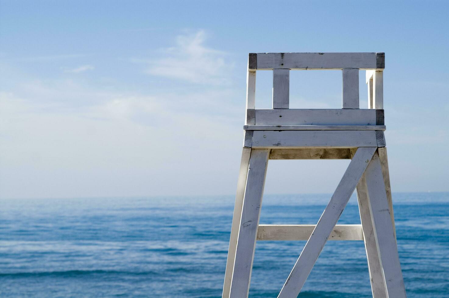 ein Rettungsschwimmer Stuhl Sitzung auf ein Strand foto