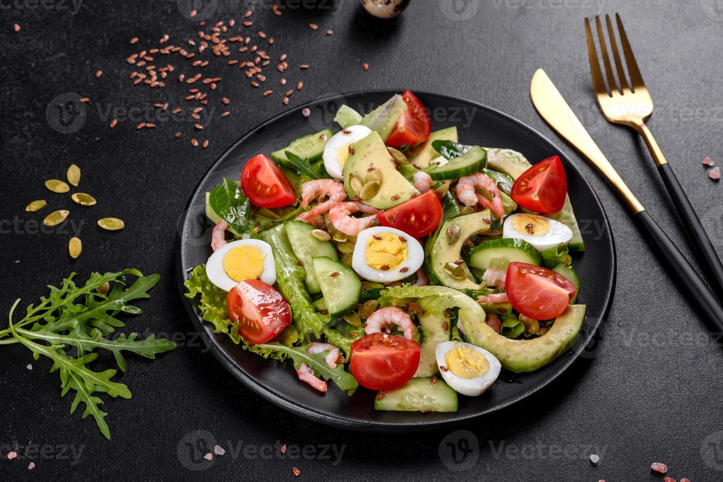 Salat mit Garnelen, Avocado, Gurke, Kürbiskernen und Leinsamen mit Olivenöl foto