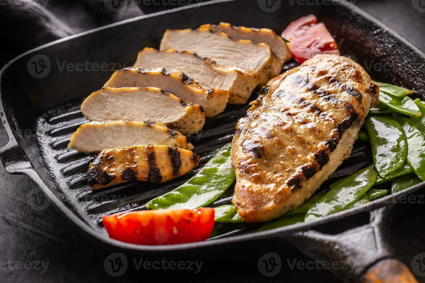 gegrillt Hähnchen Brust im Grill schwenken mit Süss Erbsen und und Tomaten foto