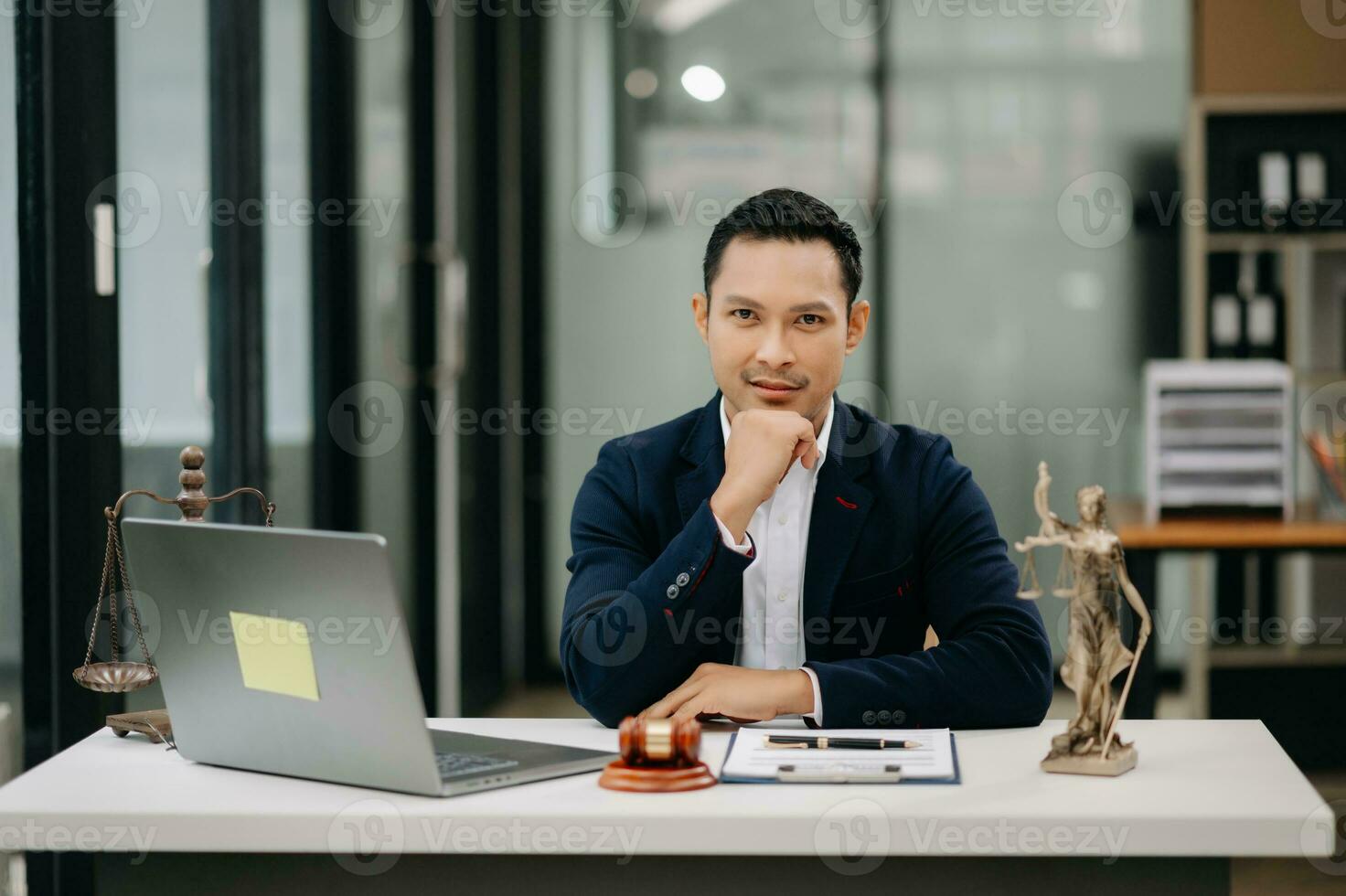 Gerechtigkeit und Gesetz Konzept .asiatisch männlich Richter im ein Gerichtssaal auf Tabelle und Berater Arbeiten im modern Büro. foto