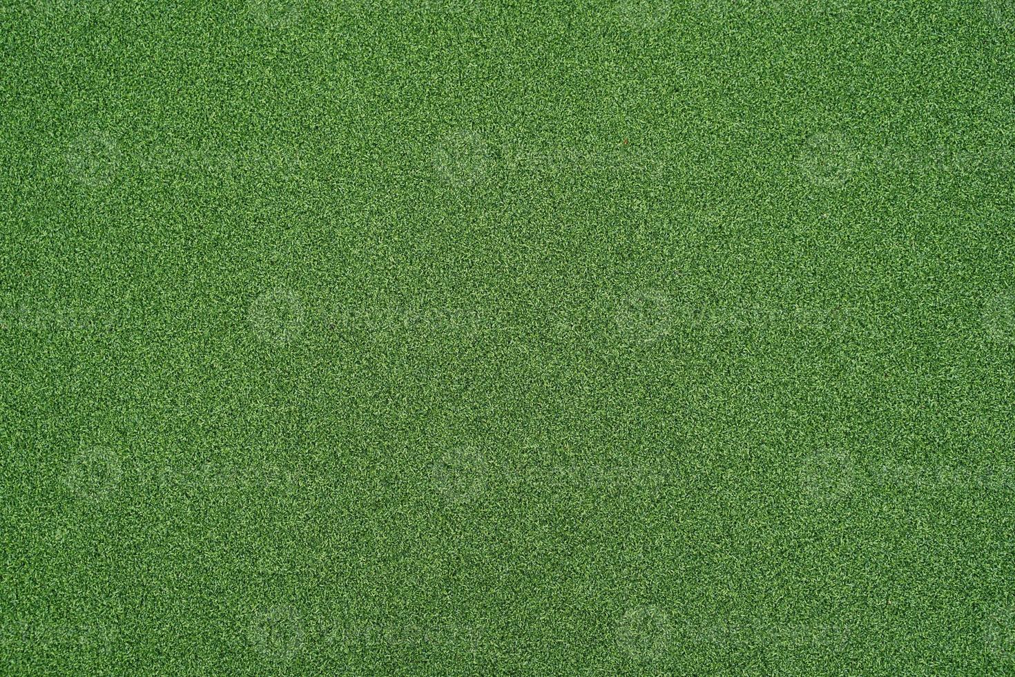 künstliches grünes Gras für den Hintergrund. grüner Rasenboden Textur Hintergrund. foto