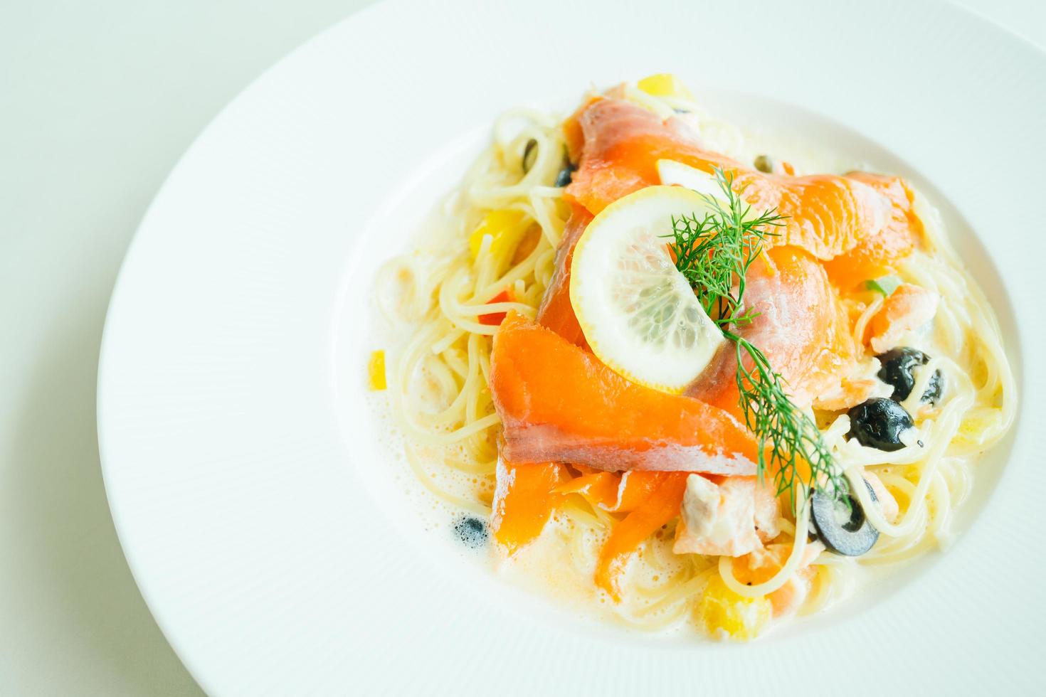 Pasta oder Spaghetti-Sahnesauce mit Lachsfleisch und Zitrone darüber on foto