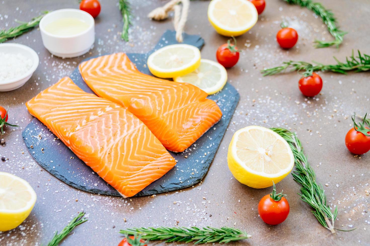 rohes und frisches Lachsfleischfilet auf schwarzem Steinschiefer foto