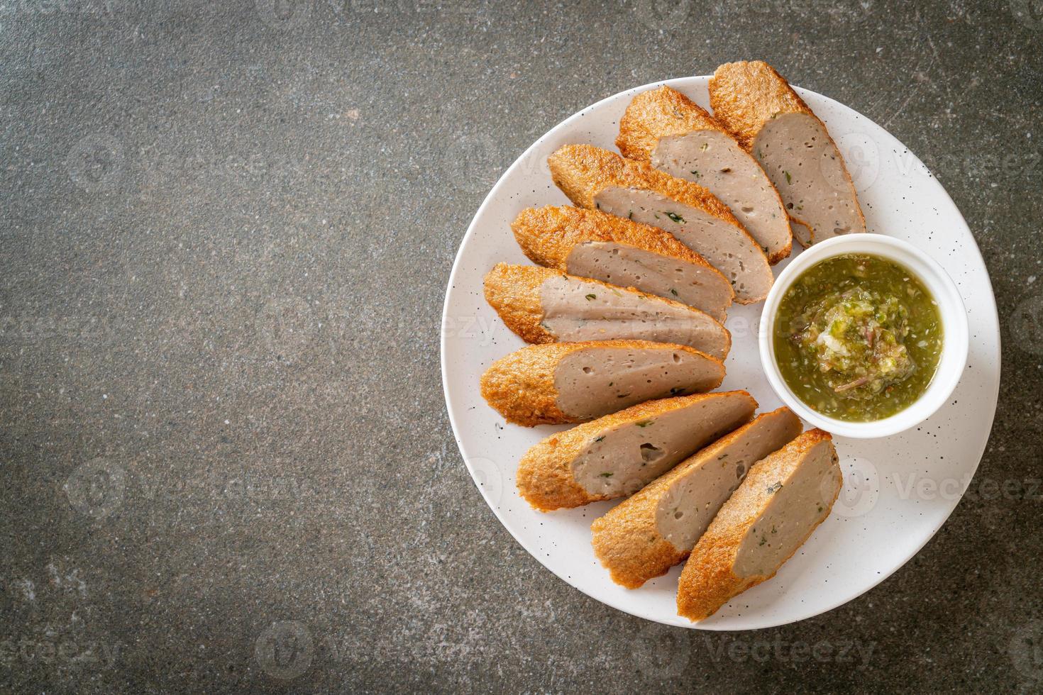 gebratener chinesischer Fischkuchen oder Fischbällchen in Scheiben geschnitten mit würziger Meeresfrüchte-Dip-Sauce foto