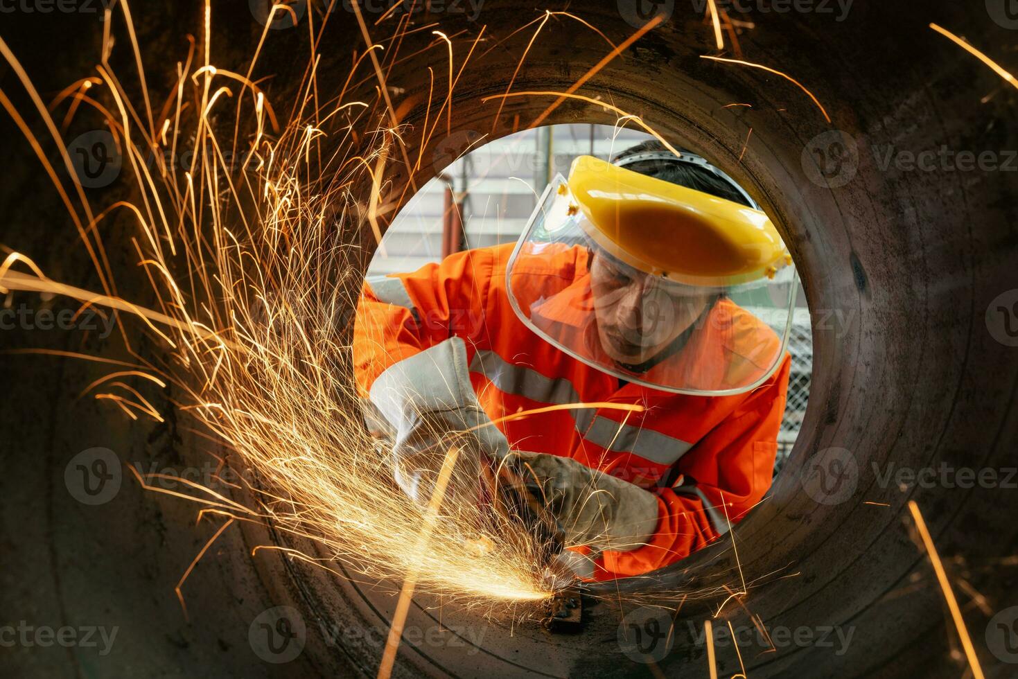 elektrisch Rad Mahlen beim industriell Arbeiter tragen ein Sicherheit Maske Schneiden Metall Rohr mit viele Scharf Funken foto