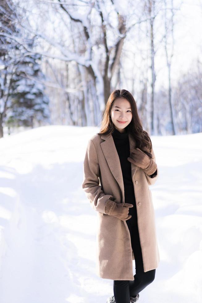 Porträt junge schöne asiatische Frau lächelt glückliche Reise und genießt mit Schnee Wintersaison foto