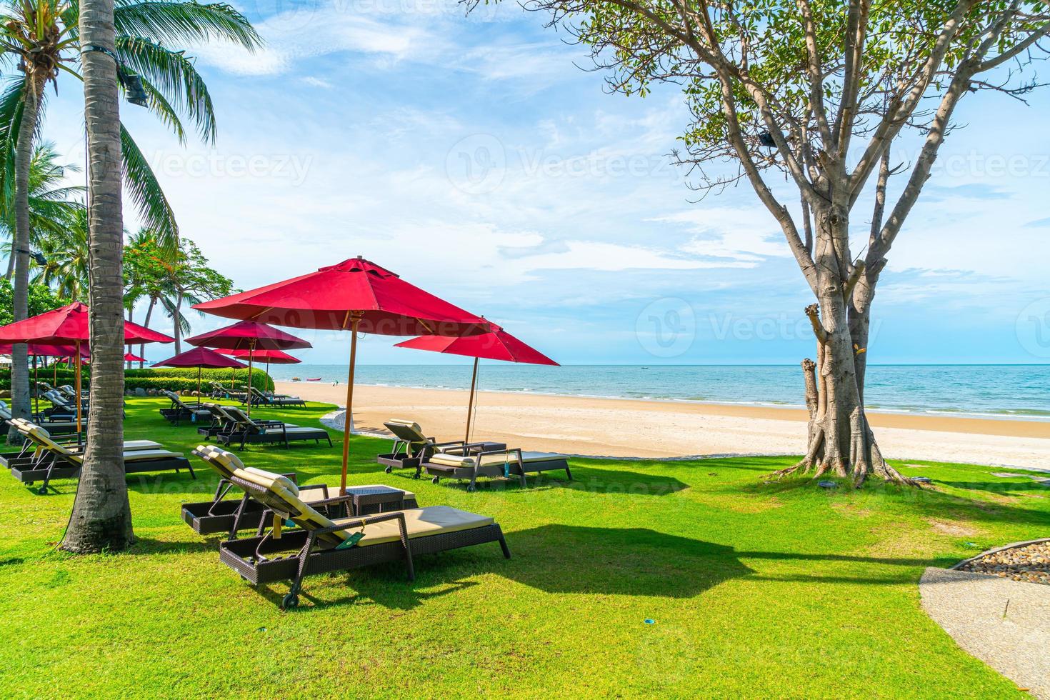 Strandkörbe und Sonnenschirme mit Ozean Meer Strand Hintergrund foto