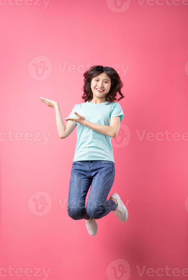 fröhliches junges Mädchen, das auf den Hintergrund springt foto
