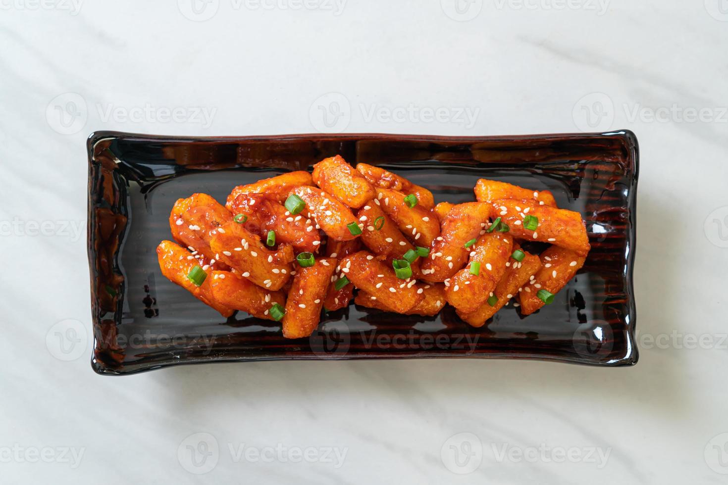 frittierter koreanischer Reiskuchen oder Tteokbokki, aufgespießt mit scharfer Sauce - koreanische Küche food foto