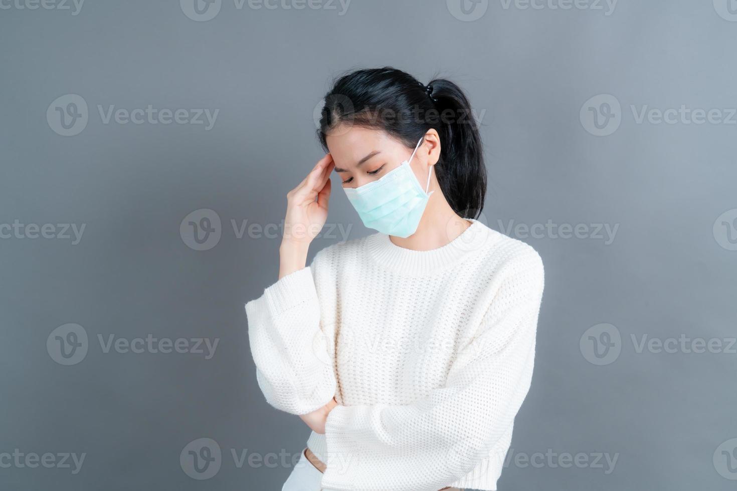 asiatische frau, die eine medizinische gesichtsmaske trägt, schützt filterstaub pm2.5 gegen verschmutzung, antismog und covid-19 foto