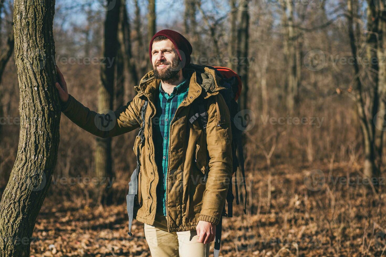 jung Hipster Mann Reisen mit Rucksack im Frühling Herbst Wald foto