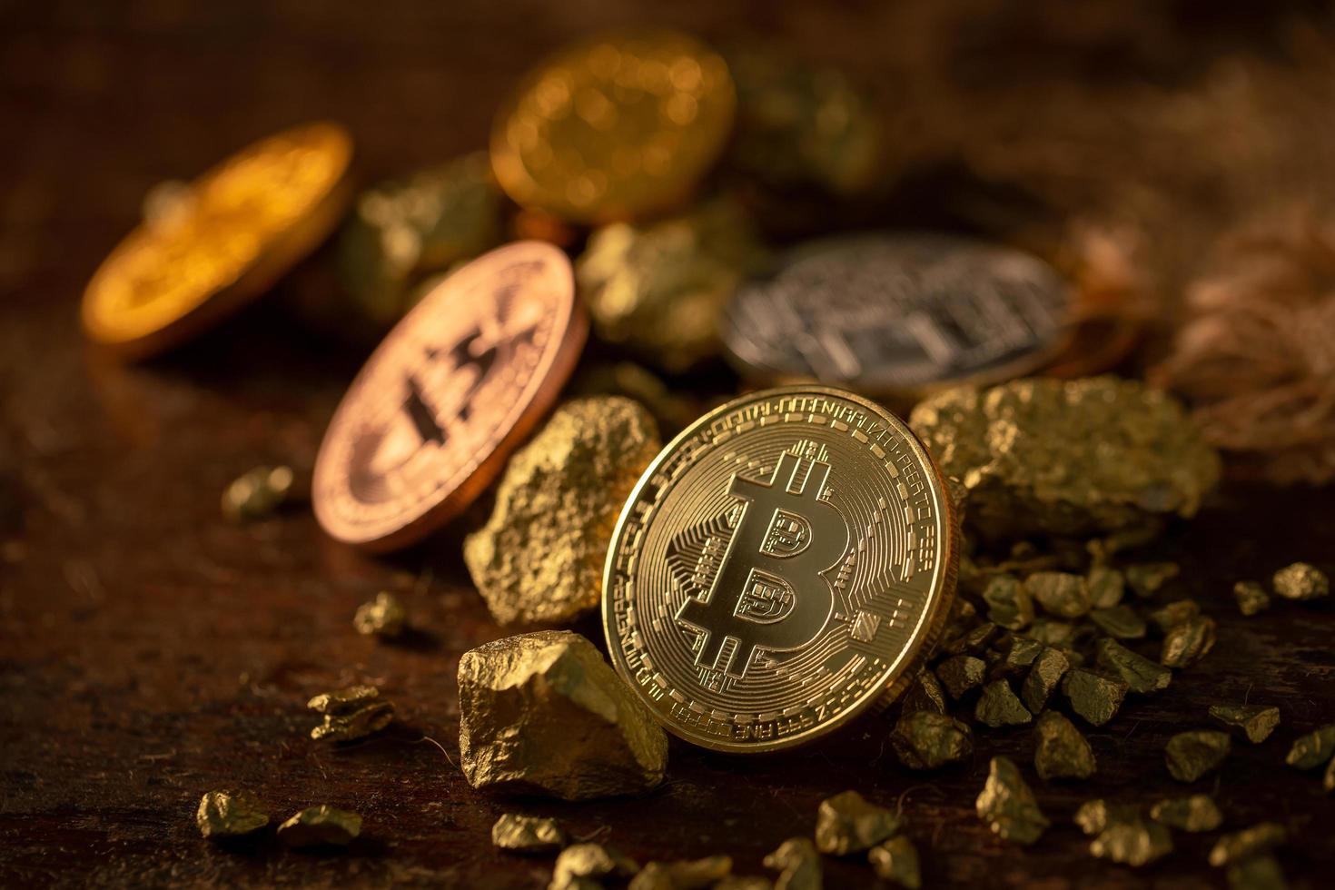 Gold-Bitcoin physische Bitcoin-Kryptowährung und Gold-Nugget-Körner. Geschäftskonzept foto