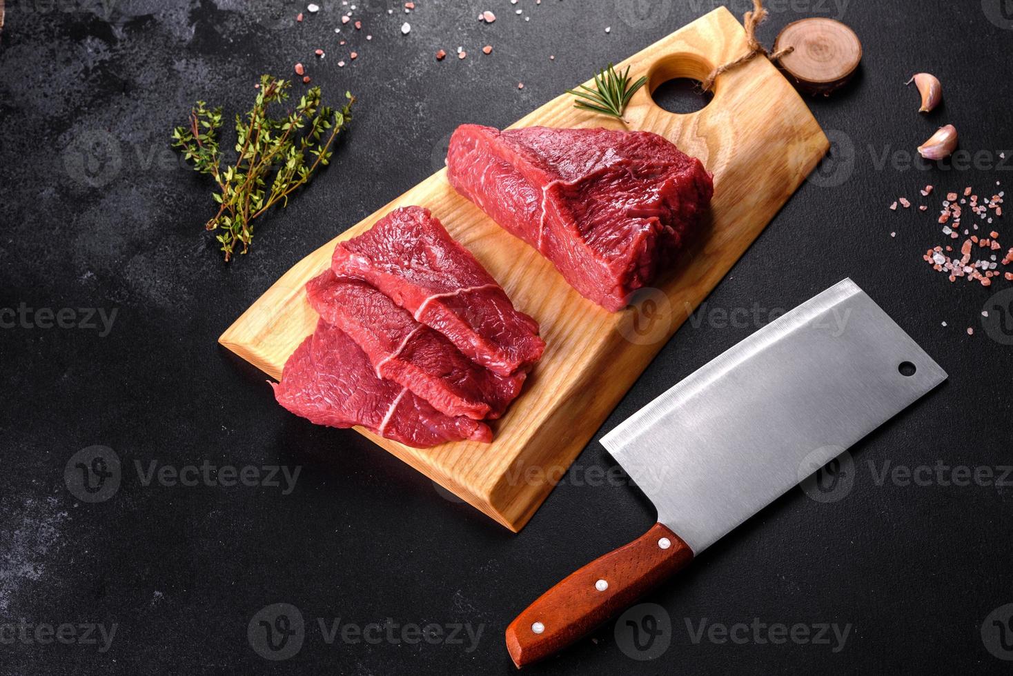 frisches rohes Rindfleisch für ein köstliches saftiges Steak mit Gewürzen und Kräutern foto