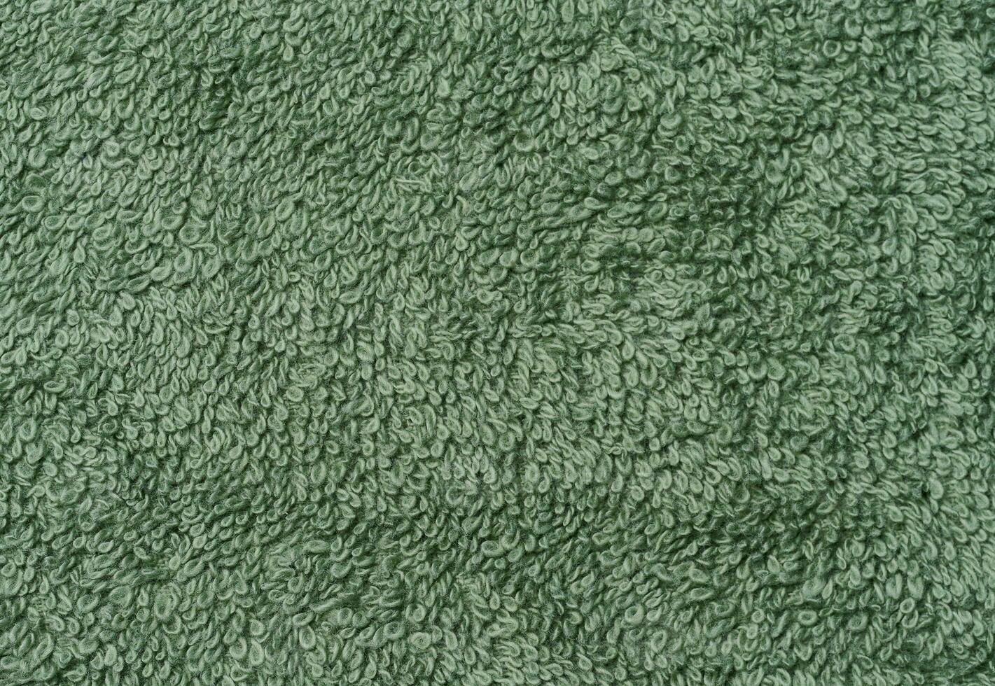 Textur von ein Grün Frottee Baumwolle Handtuch, Leinwand. Makro foto