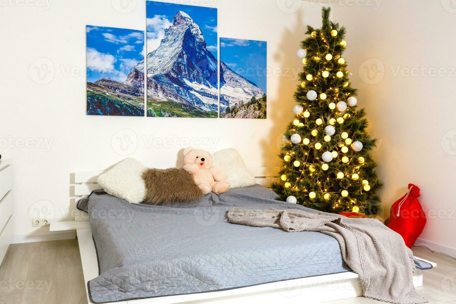 eingewickelt die Geschenke auf ein Bett in der Nähe von dekoriert Weihnachten Baum im Hotel Zimmer im das Morgen foto