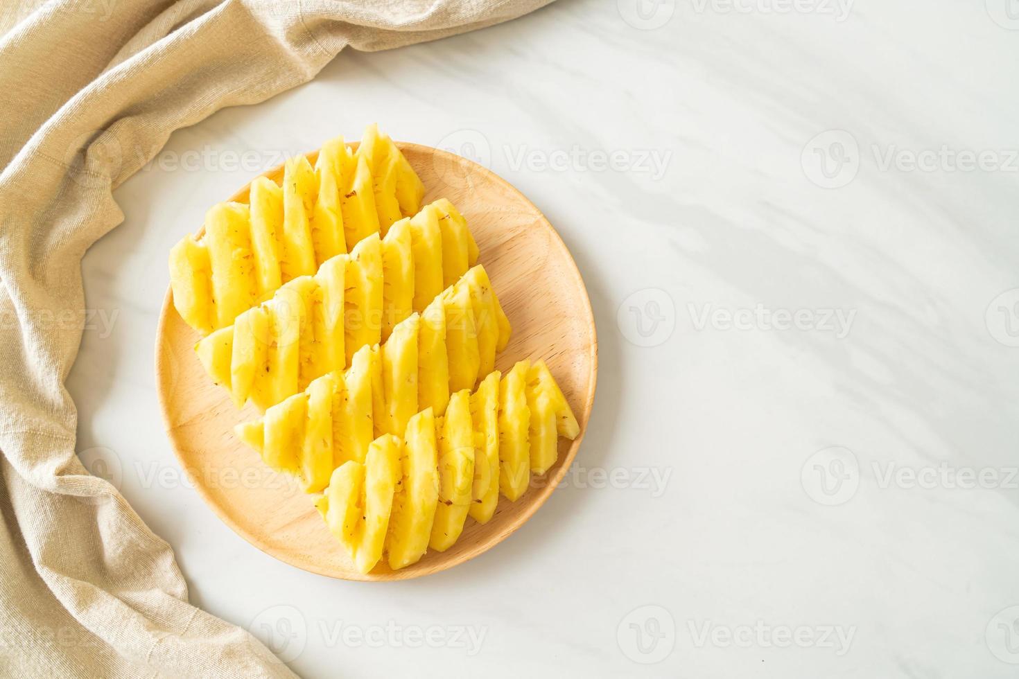 frische Ananas in Scheiben geschnitten auf weißem Teller foto