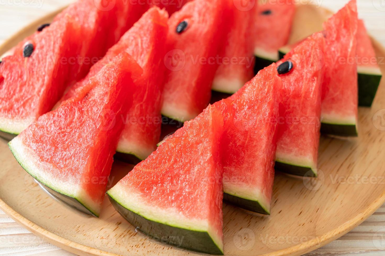 frische Wassermelone auf Holzteller geschnitten foto