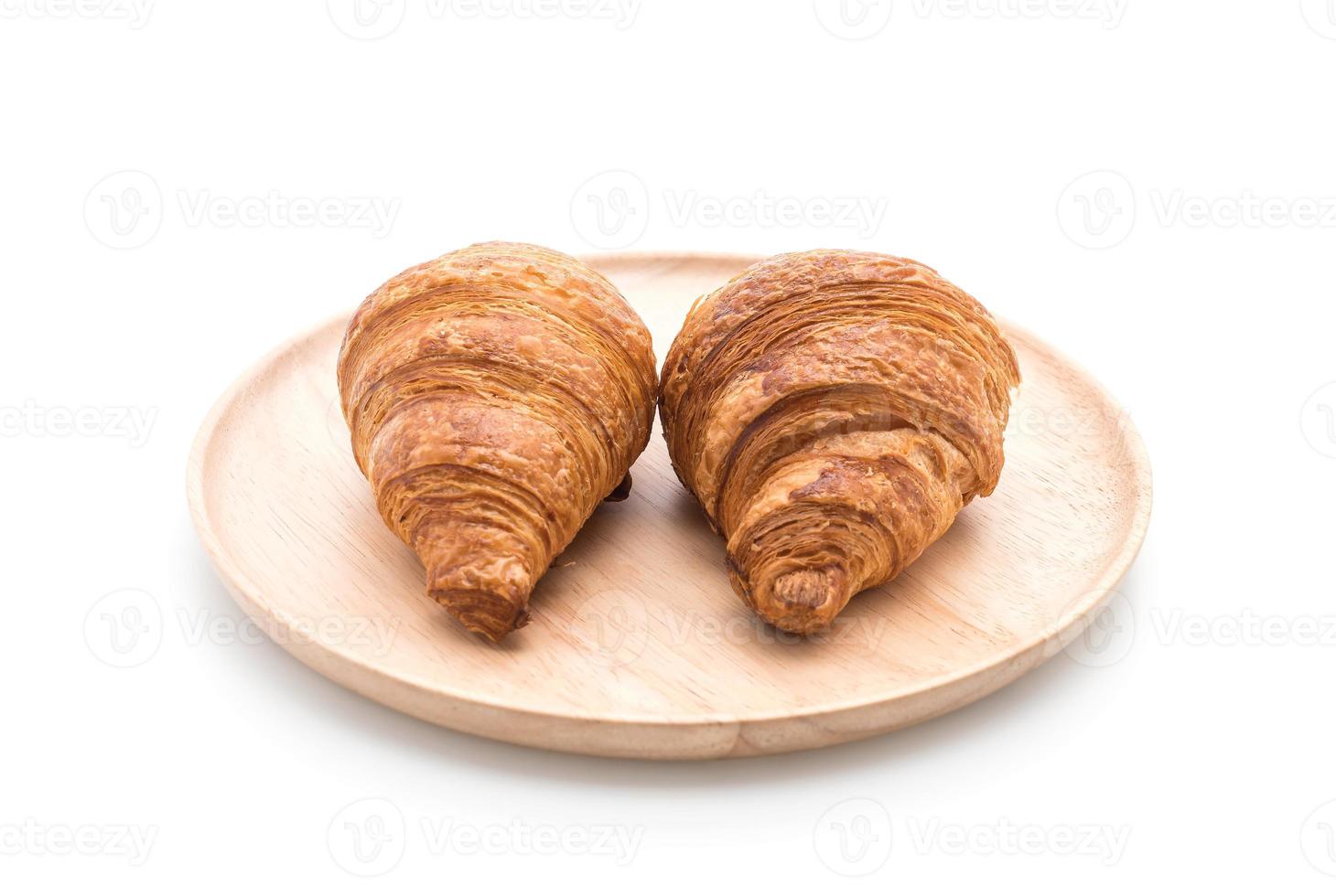 Buttercroissant auf weißem Hintergrund foto