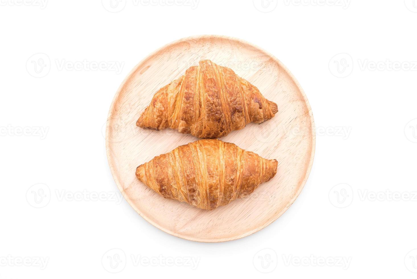 Buttercroissant auf weißem Hintergrund foto