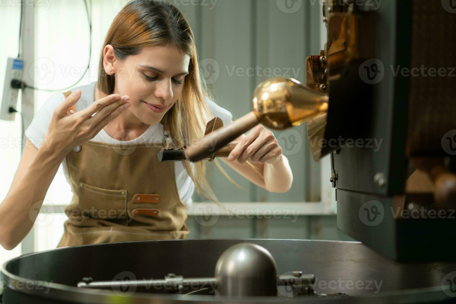 Porträt von ein jung Frau Arbeiten mit ein Kaffee Bräter Maschine foto