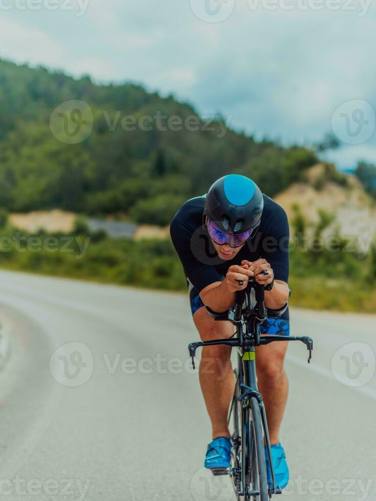 voll Länge Porträt von ein aktiv Triathlet im Sportbekleidung und mit ein schützend Helm Reiten ein Fahrrad. selektiv Fokus foto