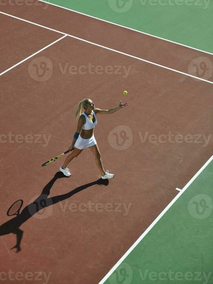 junge Frau spielt Tennis im Freien foto