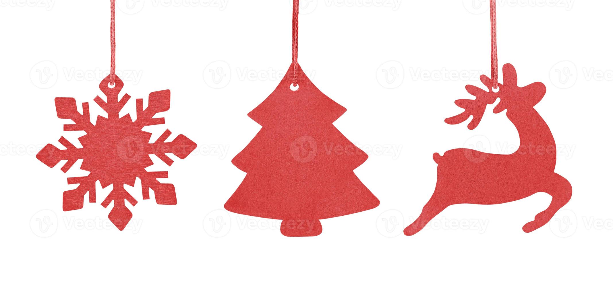 Set aus rotem hängendem Holzschmuck Weihnachtsbaum, Schneeflocke und Hirsch foto