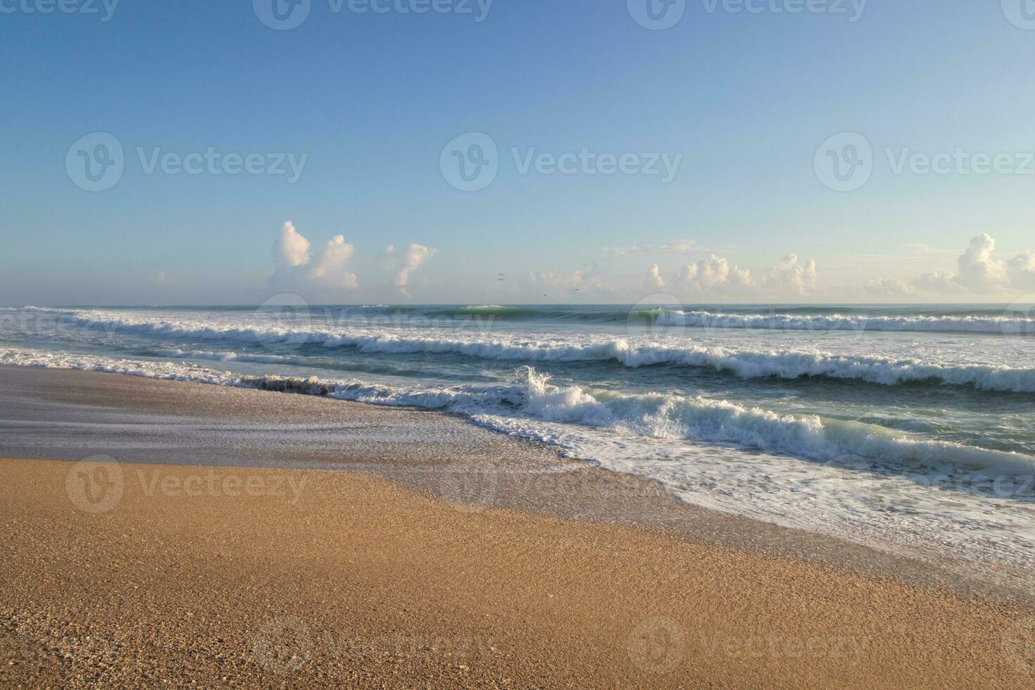 Wellen auf ein sandig Strand auf ein sonnig Morgen foto