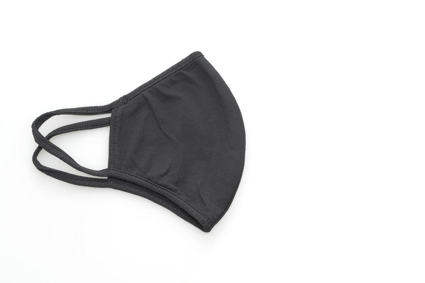 schwarze Stoffmaske zum Schutz von Covid-19 auf isoliertem weißem Hintergrund foto