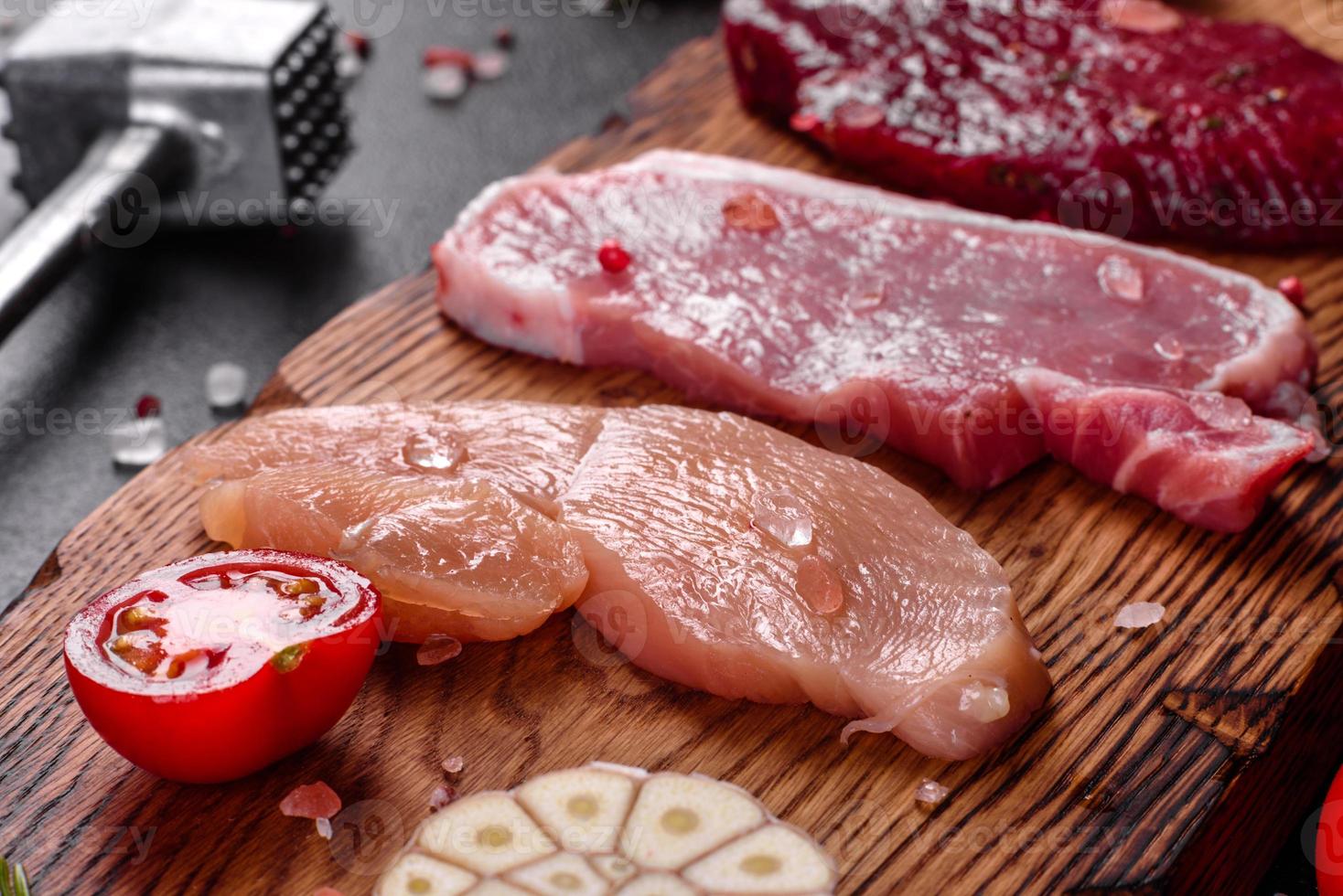 frisches saftiges Steak vom Rind, Schwein und Huhn mit Gemüse foto