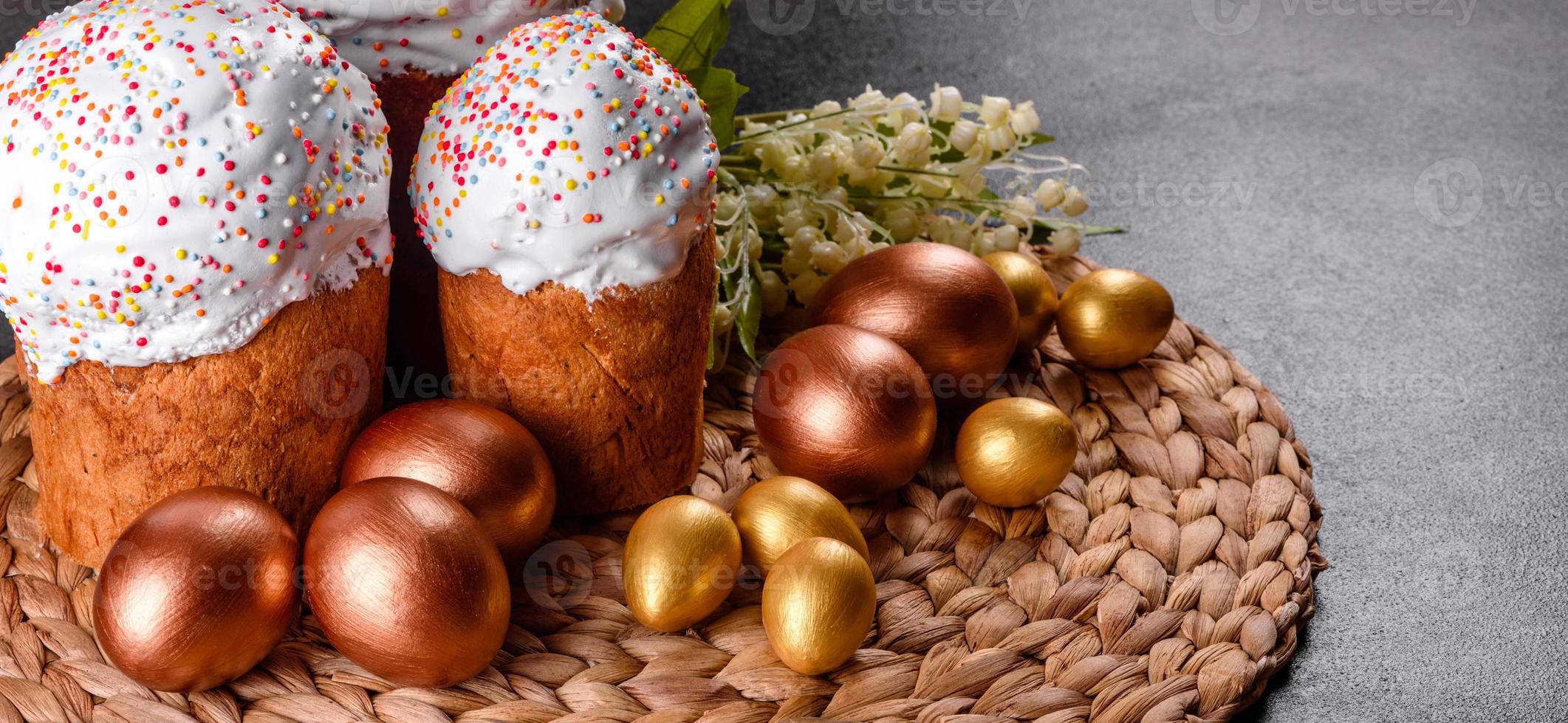 Ostereier Gold und Bronze und Osterkuchen auf dunklem Hintergrund foto