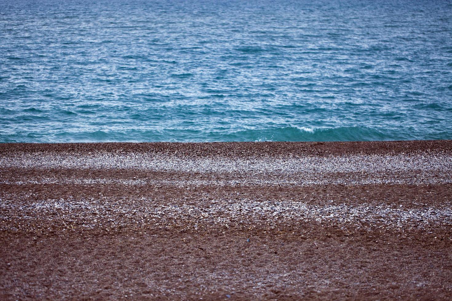 Strandsand und Meerurlaubskonzept foto