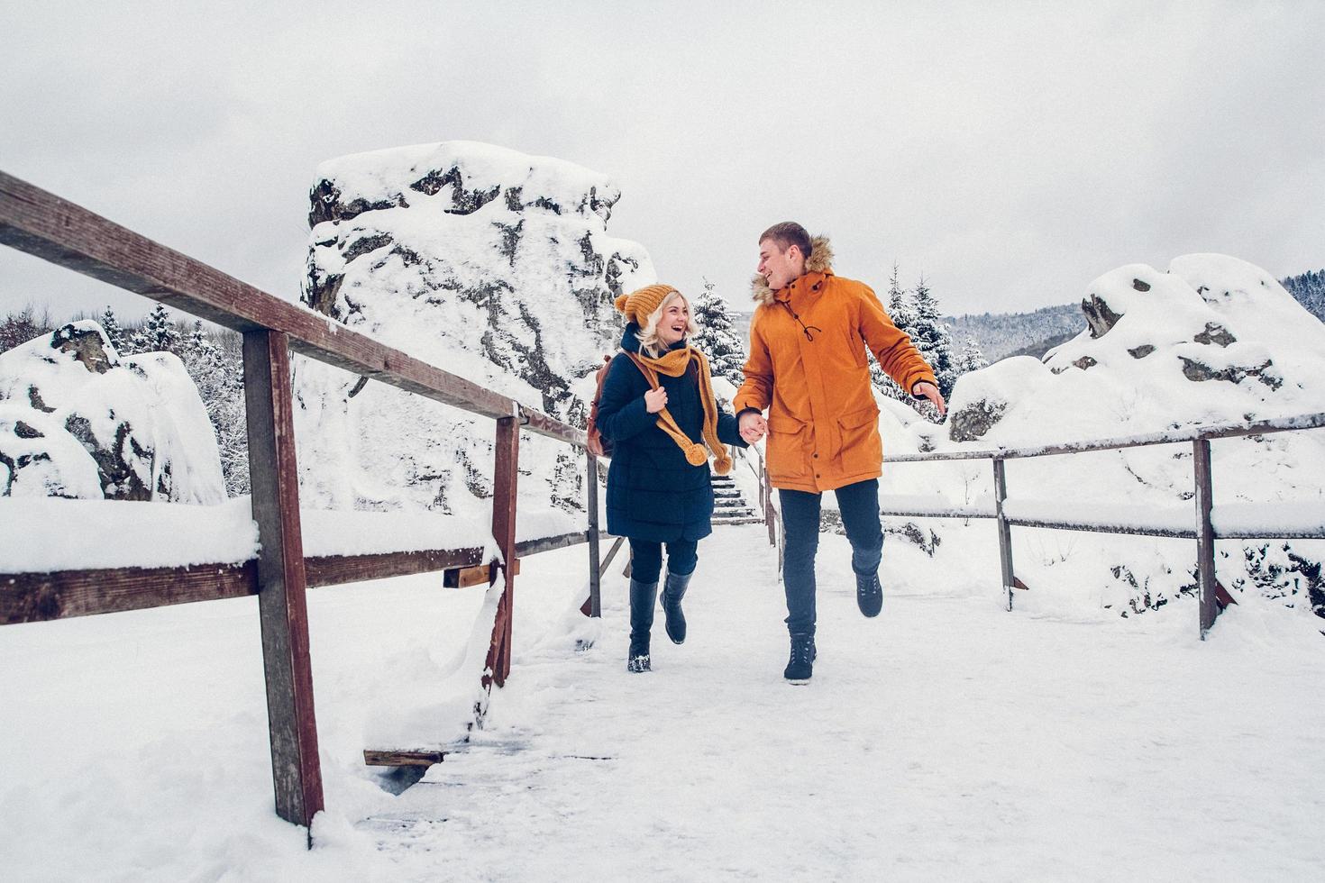 Mann und Mädchen gehen und haben Spaß im Winter im Wald foto