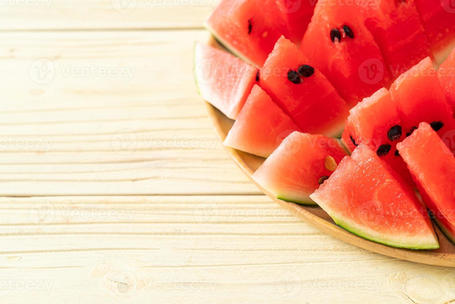 frische Wassermelone auf Holzteller geschnitten foto