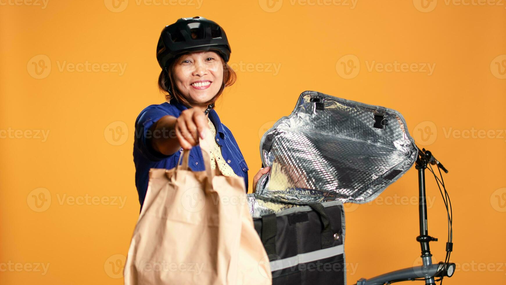 pov Schuss von Kurier ankommen zu Klient Adresse Standort, nehmen Mittagessen Tasche aus von thermic Rucksack. heiter asiatisch Fahrrad Fahrer liefern wegbringen Essen zu Kunde, isoliert Über Studio Hintergrund foto