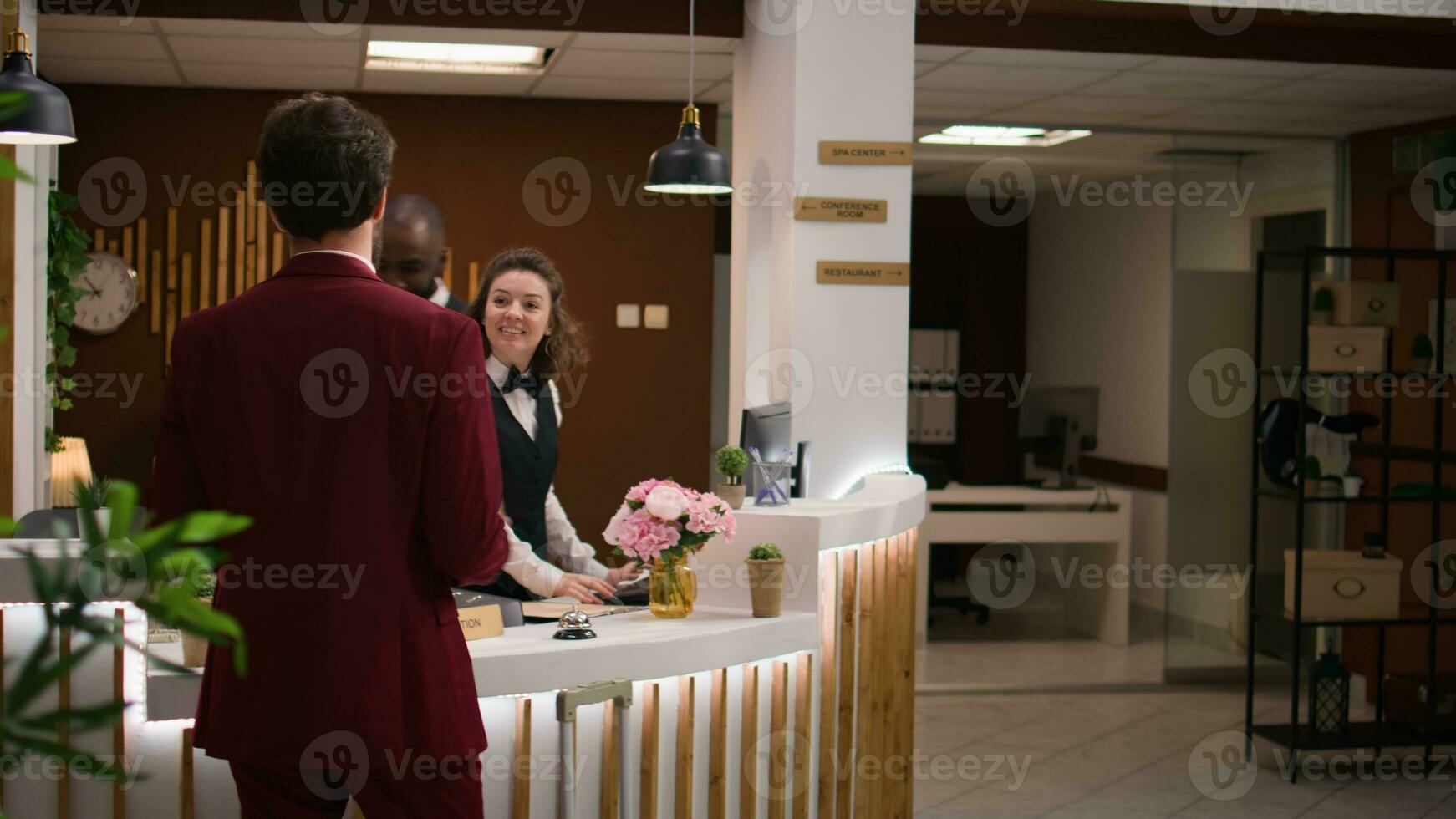 Geschäftsmann Ringe Bedienung Glocke im Empfangshalle zu Anruf zum Hotel Portier Personal und erhalten Hilfe beim prüfen In. Fachmann ankommen beim Resort und fragen Über Ausstattung während Arbeit Reise. foto