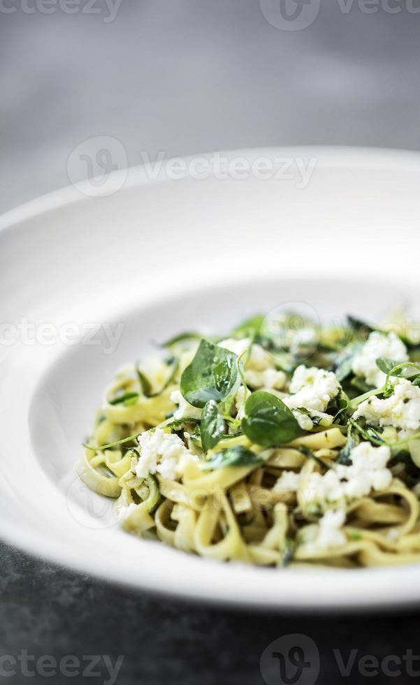 Gourmet italienischer Bio-Ricotta und frische gemischte Kräuter-Tagliatelle auf Teller foto