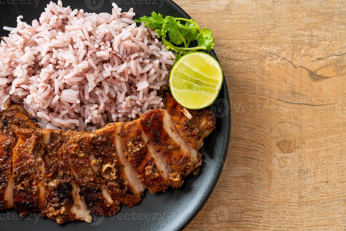 würzig gegrilltes jamaikanisches Jerk Chicken mit Reis - jamaikanische Küche foto