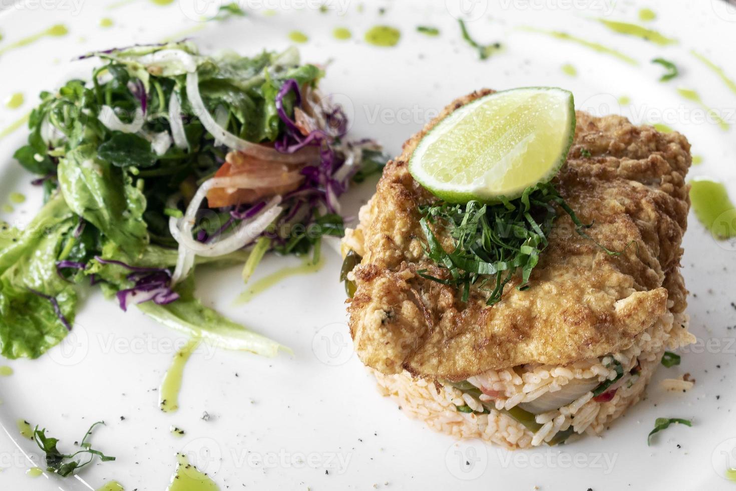 frisch gebratenes Kabeljaufilet im Teigmantel leichtes Sommer-Mittagessen mit baskischem gemischtem Gemüse würzigem Reis und Salat foto