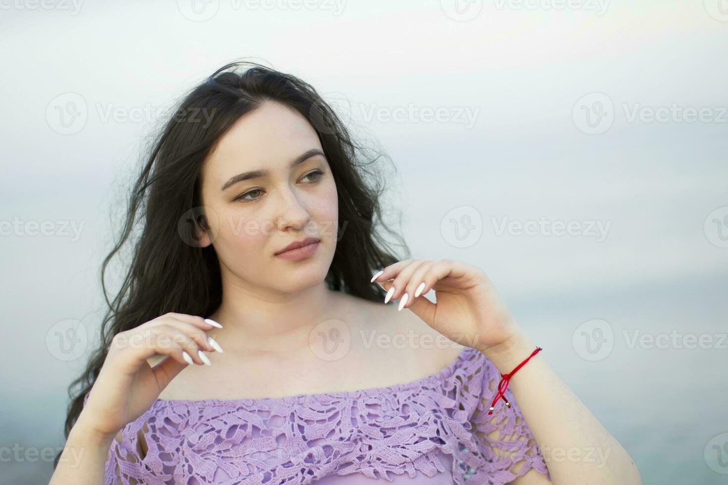 Porträt von ein Brünette Mädchen durch das Meer foto