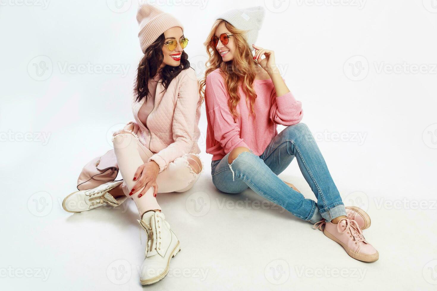 zwei freunde chillen auf Weiß Fußboden im Studio. süß Rosa Outfit. stilvoll Schuhe. foto