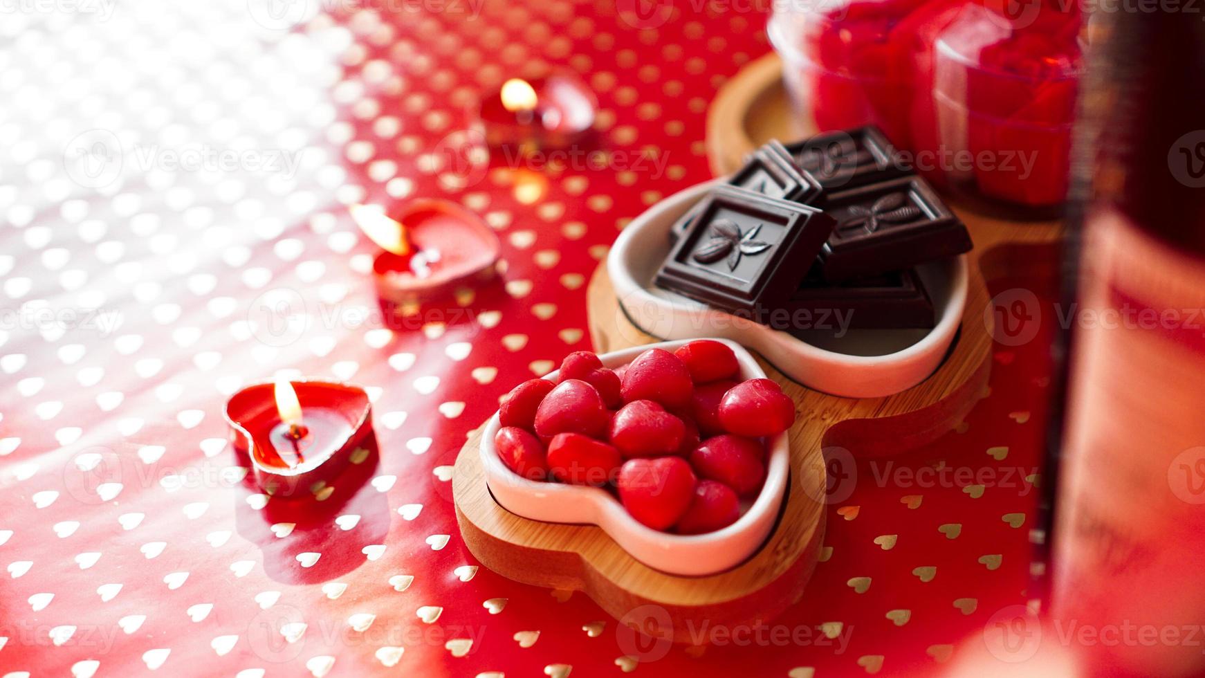 Pralinen und Süßigkeiten auf herzförmigen Tellern foto