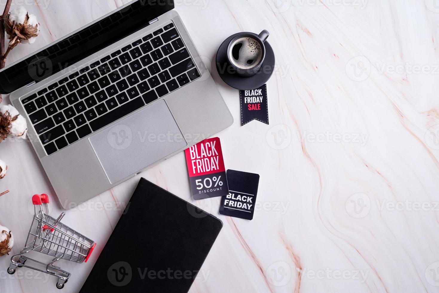 Schwarze Freitagsverkaufswörter auf dem Tag, Arbeitsplatz mit Laptop, Notebook foto