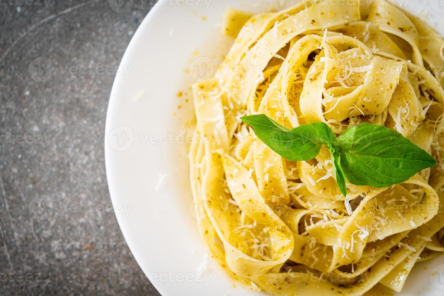 Pesto-Fettuccine-Nudeln mit Parmesankäse darüber foto