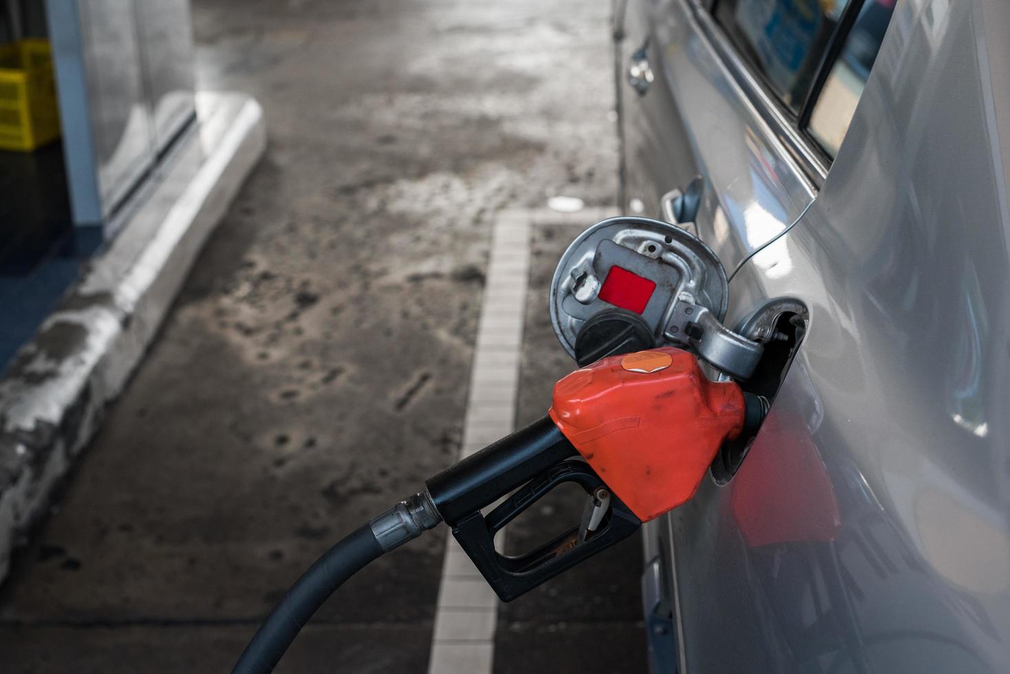 Pumpen von Benzinkraftstoff im Auto an der Tankstelle foto