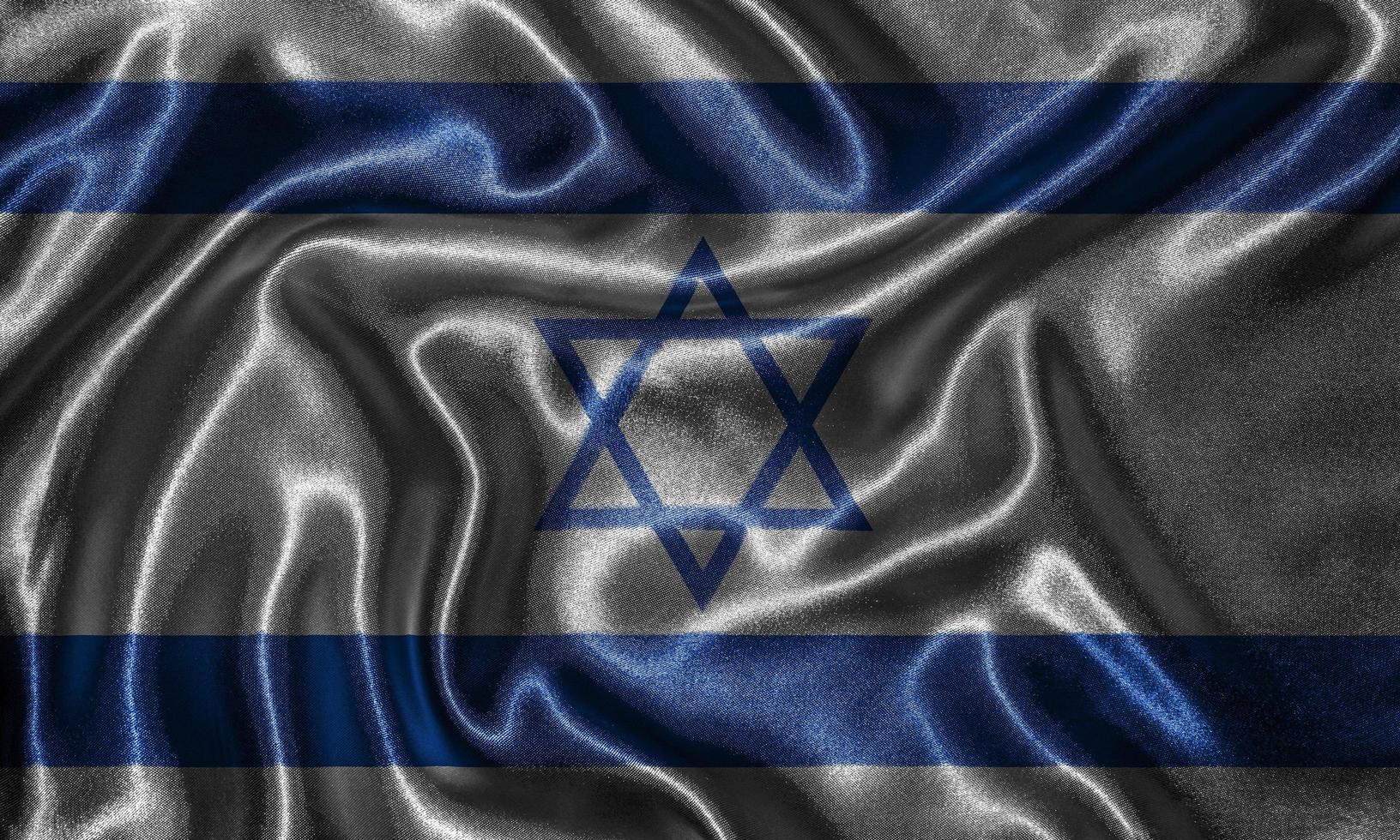 Tapete von israelischer Flagge und wehende Flagge von Stoff. foto