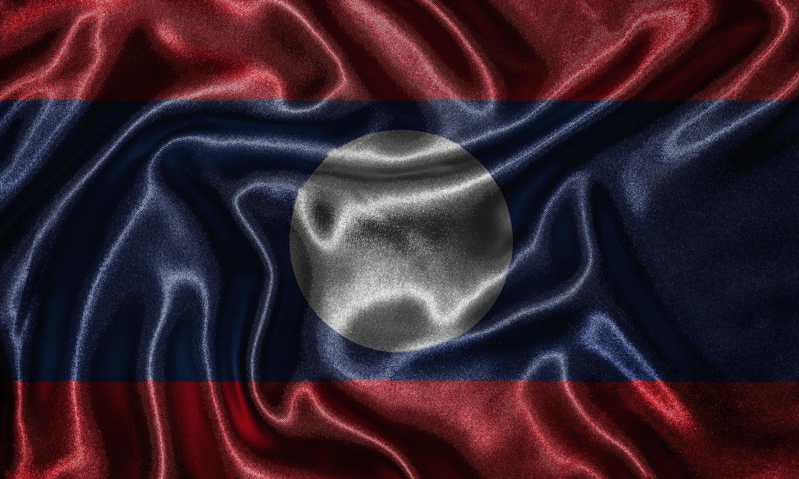 Tapete von Laos-Flagge und wehende Flagge von Stoff. foto