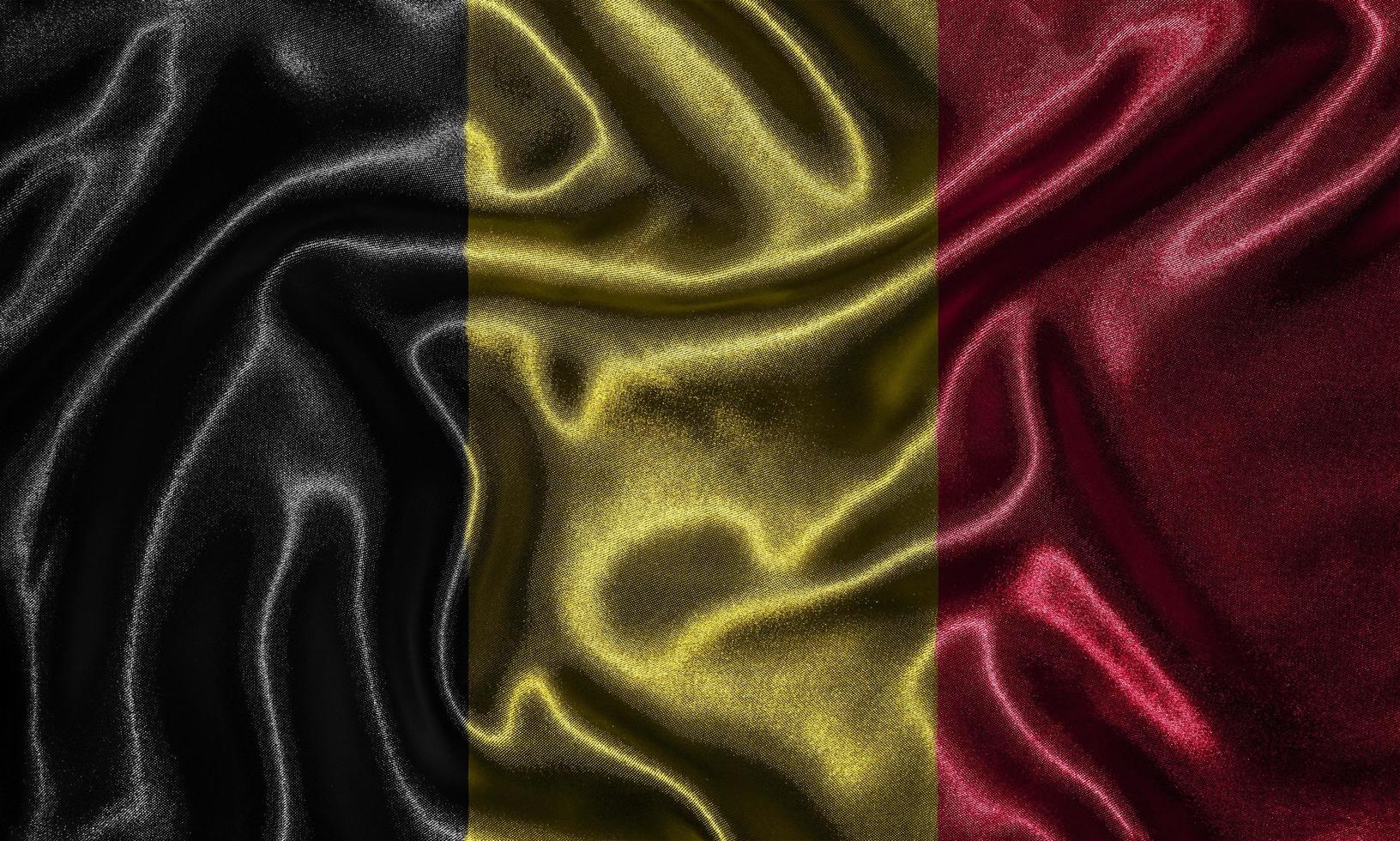 Tapete von belgischer Flagge und wehende Flagge von Stoff. foto